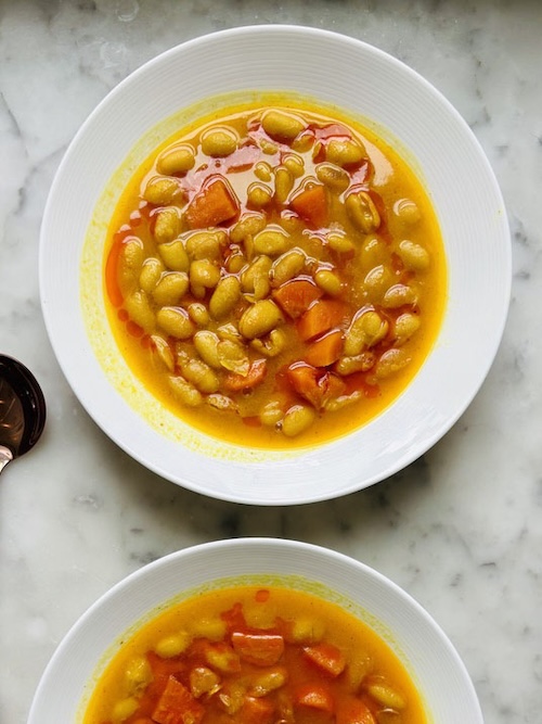 Bowls of turmeric white bean soup.