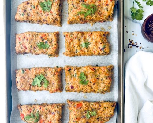 Ground chicken patties on a sheet pan.