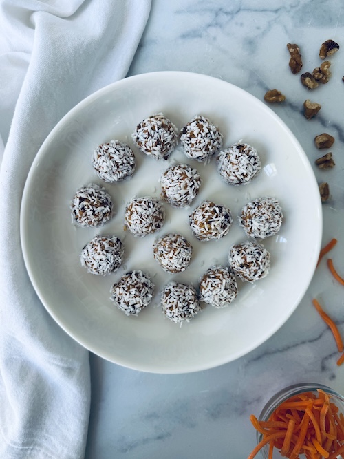 No bake carrot cake energy bites on a plate.
