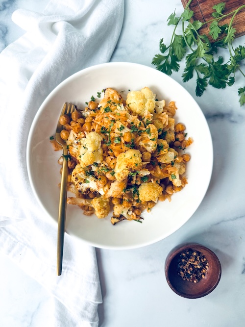 A bowl of chili lime cauliflower with chickpeas.