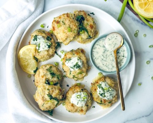 Cheesy zucchini patties with dip.