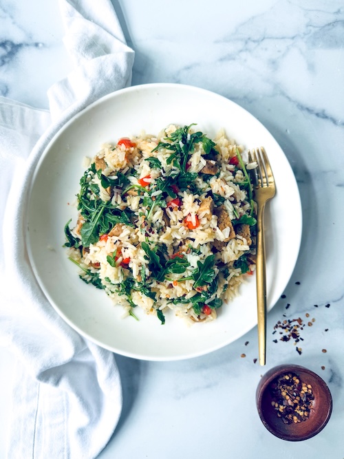 Italian sausage and arugula mixed with rice.