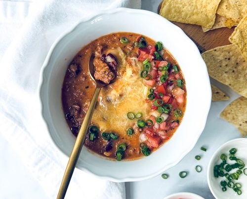 A bowl of queso beef chili.