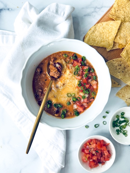 A bowl of queso beef chili.