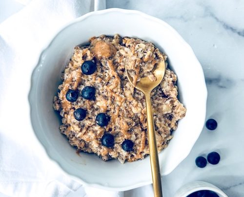 A bowl of superfood porridge with blueberries.