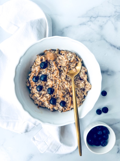 A bowl of superfood porridge with blueberries.