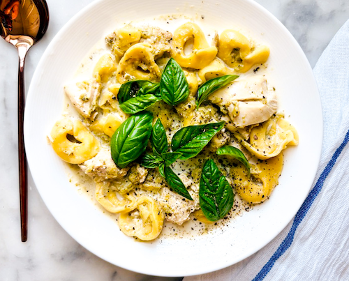 Bowl of chicken and broccoli with tortellini.