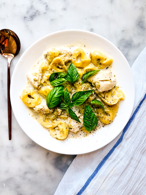 Bowl of chicken and broccoli with tortellini.