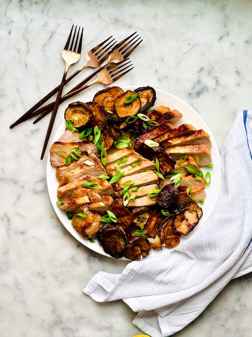 Sliced miso pork chops with mushrooms.