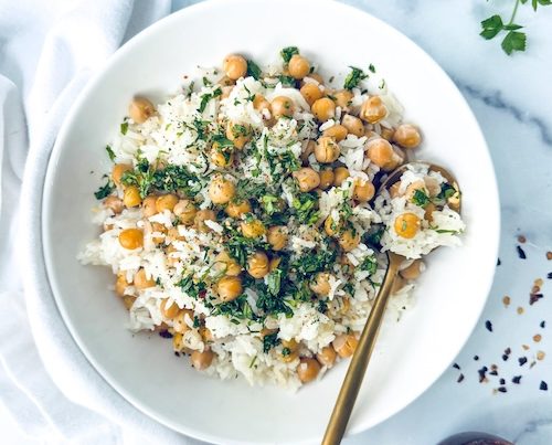 Aglio olio chickpeas over a bowl of rice.