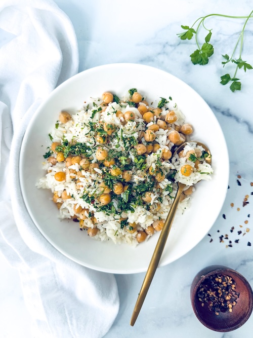 Aglio olio chickpeas over a bowl of rice.