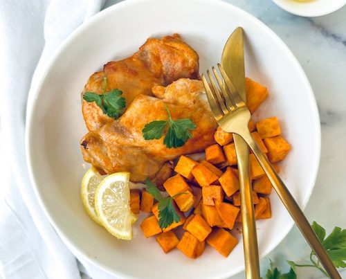 Roasted lemon chicken with cubed sweet potatoes.