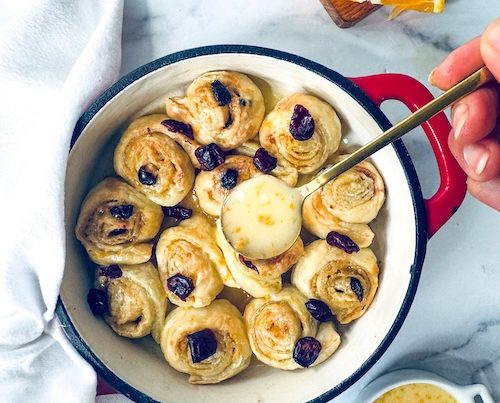 Cranberry orange cinnamon rolls in a baking dish.