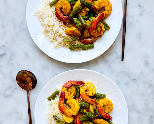 Shrimp and green bean curry over white rice.