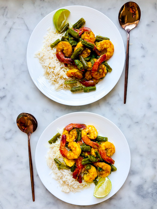 Shrimp and green bean curry over white rice.