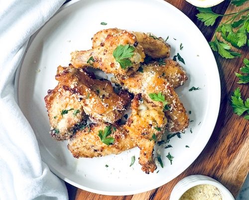 Baked chicken wings on a plate.