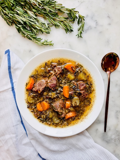 A bowl of beef and wild rice soup.