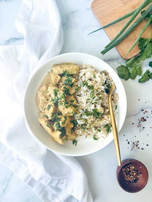 A bowl of peanut chicken with rice.