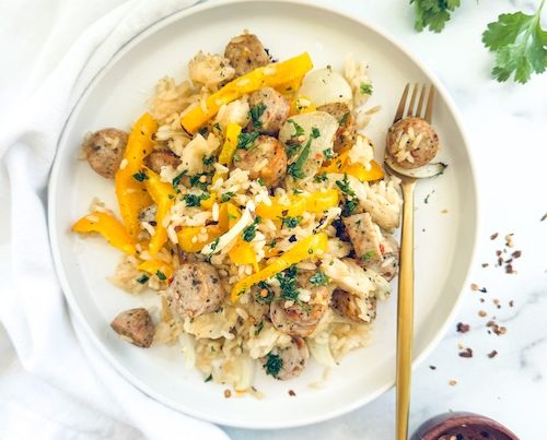 Sheet pan chicken sausage and peppers over rice.