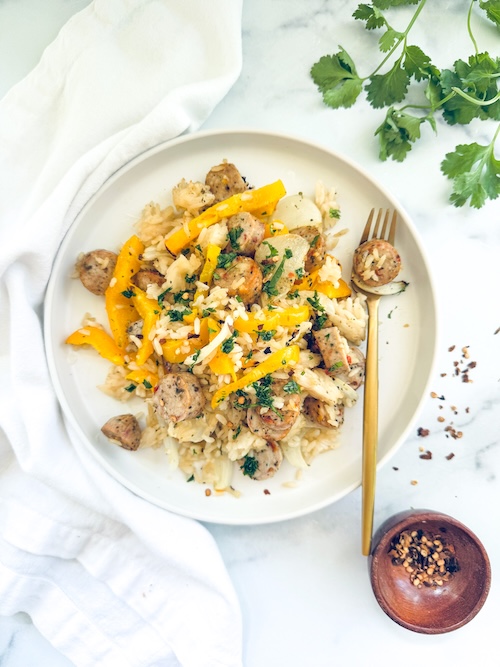 Sheet pan chicken sausage and peppers over rice.