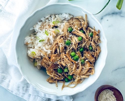 Shredded sesame garlic chicken over rice.