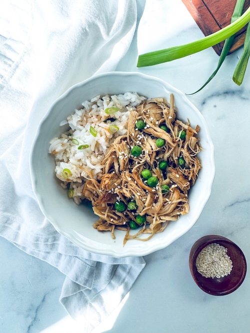Shredded sesame garlic chicken over rice.