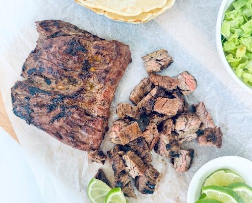 Skirt steak on a cutting board.