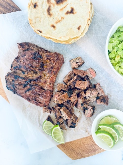 Skirt steak on a cutting board.