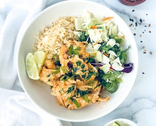 A bowl of Thai chicken curry over rice.