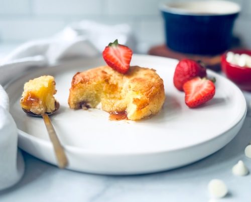 White chocolate strawberry lava cake on a plate.
