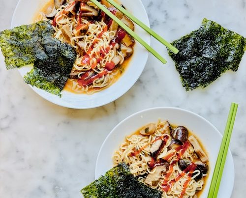 Two bowls of spicy mushroom ramen noodles.