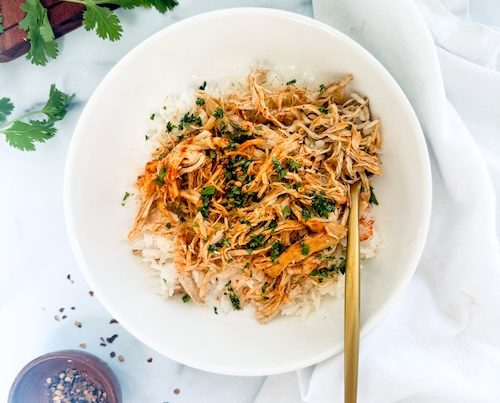 Shredded Doritos Chicken over a bowl of rice.