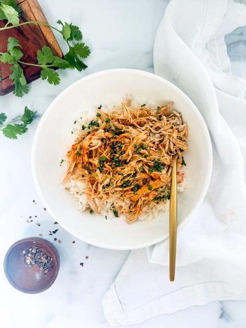 Shredded Doritos Chicken over a bowl of rice.