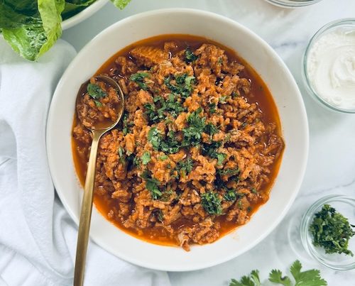 Large bowl of turkey taco filling for lettuce wraps.