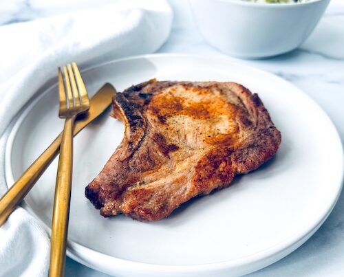 Air fryer pork chop on a plate.