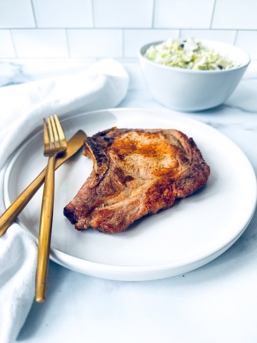 Air fryer pork chop on a plate.