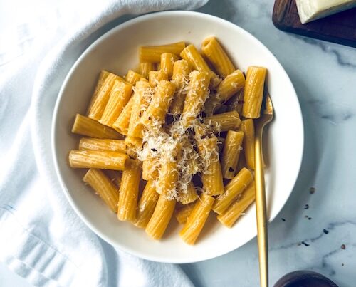 Garlic butter rigatoni topped with Parmesan.
