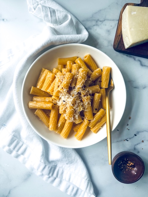 Garlic butter rigatoni topped with Parmesan.