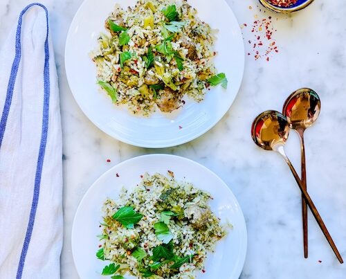 Rice with broccoli and sausage in two bowls.