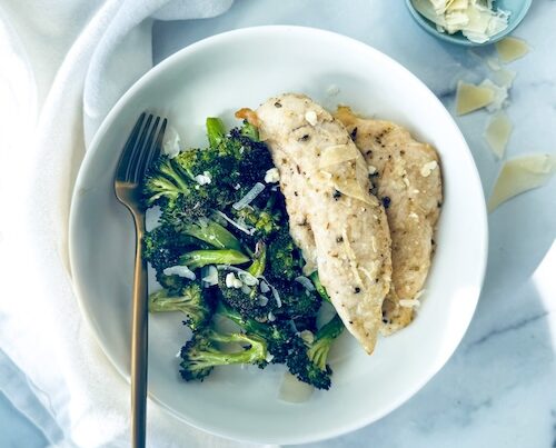 Garlic Parmesan chicken tenders and broccoli on a plate.