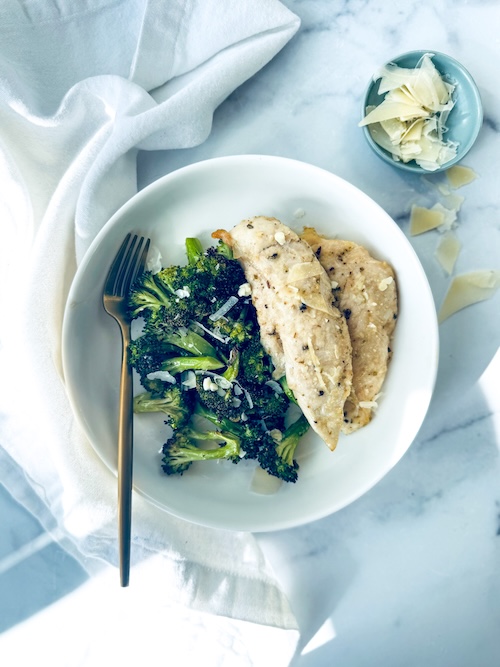 Garlic Parmesan chicken tenders and broccoli on a plate.