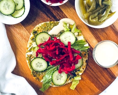 Vegan falafel smashed taco on a cutting board.