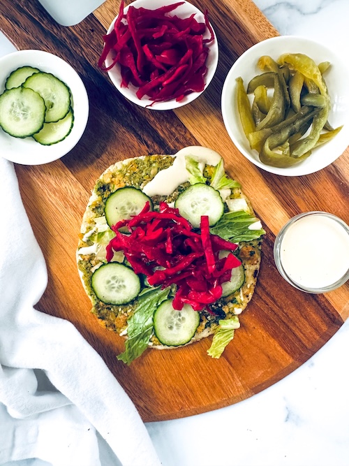 Vegan falafel smashed taco on a cutting board.