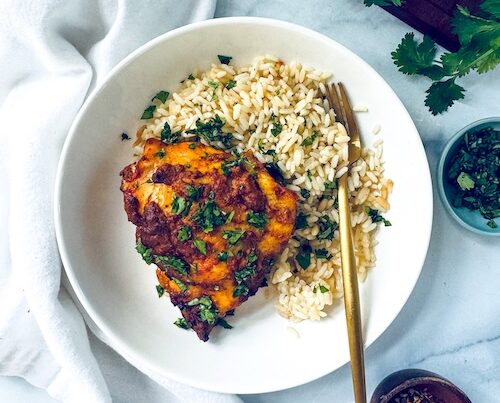 Tandoori chicken thighs with brown rice.