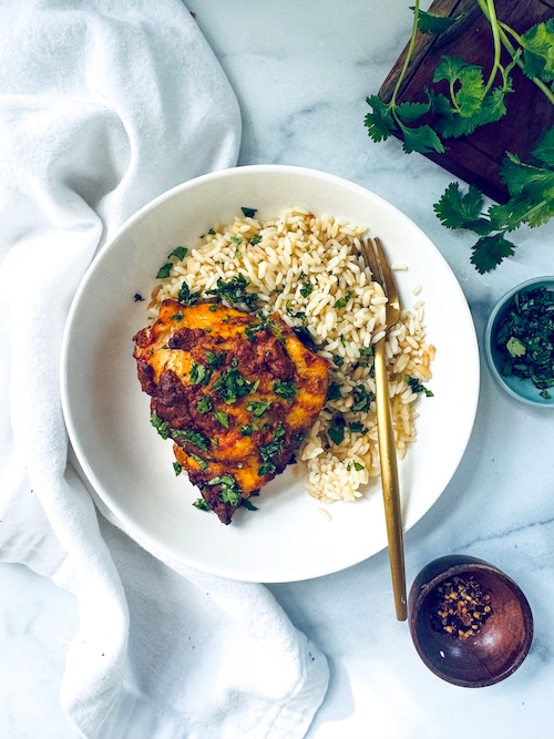 Tandoori chicken thighs with brown rice.