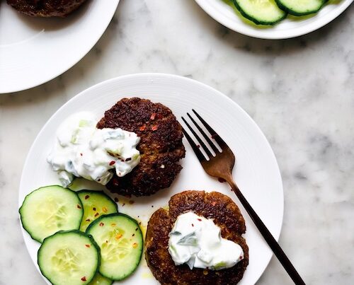 Grilled lamb patties and sliced cucumbers.