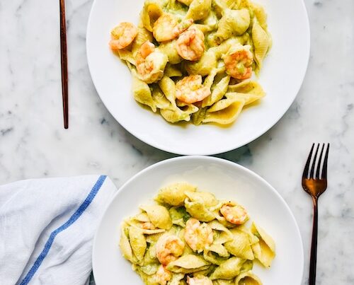 Two bowls of shrimp and broccoli pasta.
