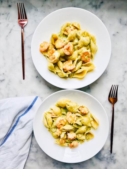 Two bowls of shrimp and broccoli pasta.