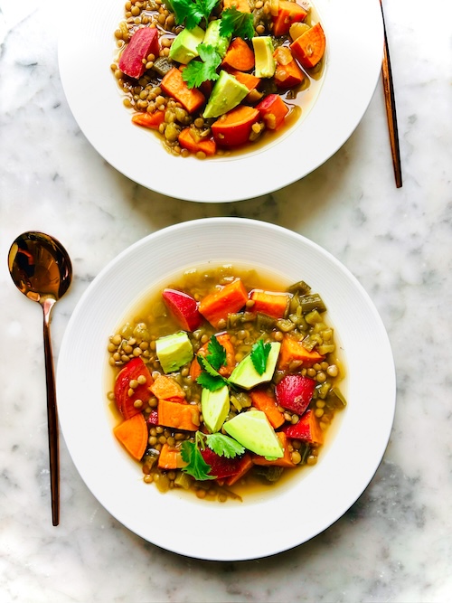 Two bowls of lentil sweet potato soup.