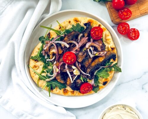 Vegan mushroom shawarma on a pita.